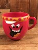 アドバタイジングキャラクターのファニーフェイスのビンテージのマグカップ