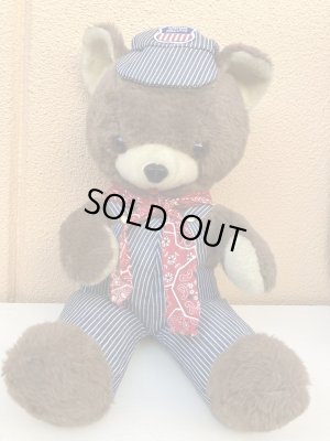 ヒッコリーストライプの服を着たビンテージのくまのぬいぐるみ