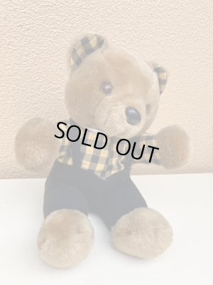 ギンガムチェックの服を着たビンテージのテディベア