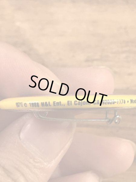 “The One With The Most Buttons Wins”と書かれたスマイルの80年代ビンテージ缶バッジ