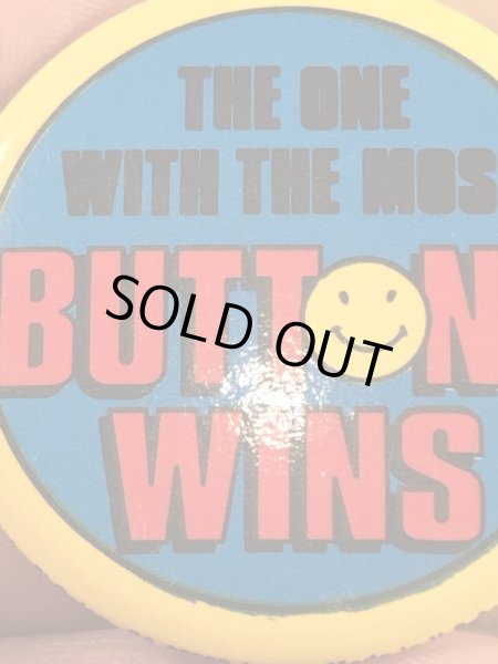“The One With The Most Buttons Wins”と書かれたスマイルの80年代ビンテージ缶バッジ
