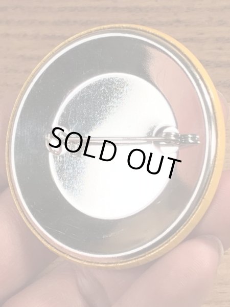 70年代頃の企業物のスマイルフェイスのビンテージの缶バッジ