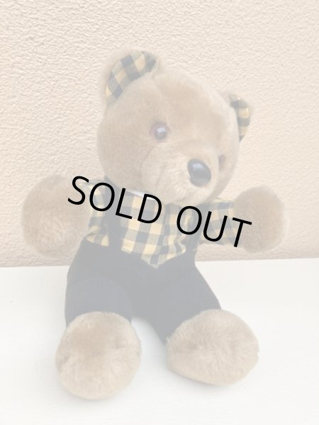 ギンガムチェックの服を着たビンテージのテディベア